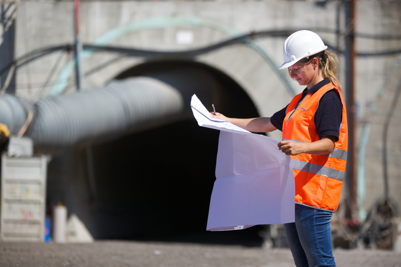 Environmental engineering consultant reviewing technical plans at infrastructure site in Italy, supporting permitting, remediation and sustainability projects